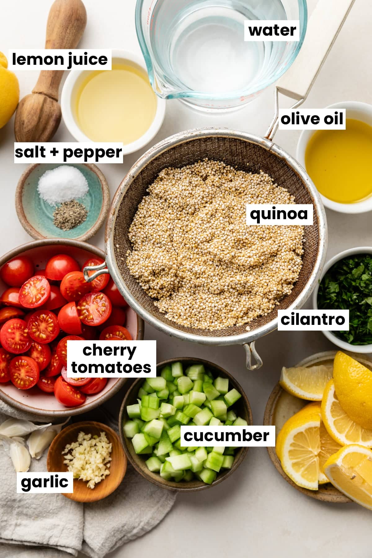 Ingredients in the recipe, including quinoa, water, cherry tomatoes, cilantro, cucumber, salt, pepper, lemon juice, olive oil, and garlic.