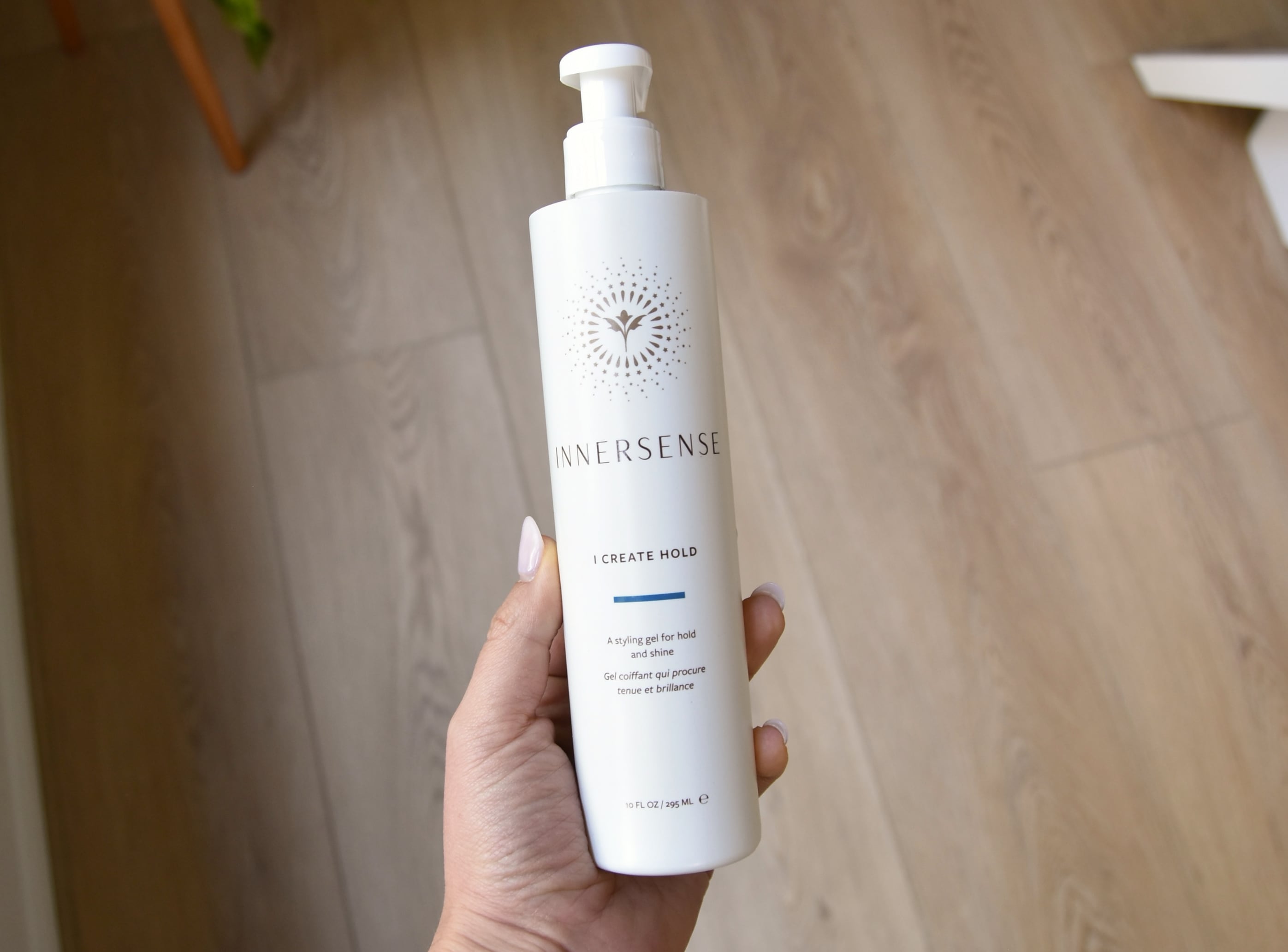 Holding a bottle of the I Create Hold Hair Gel.