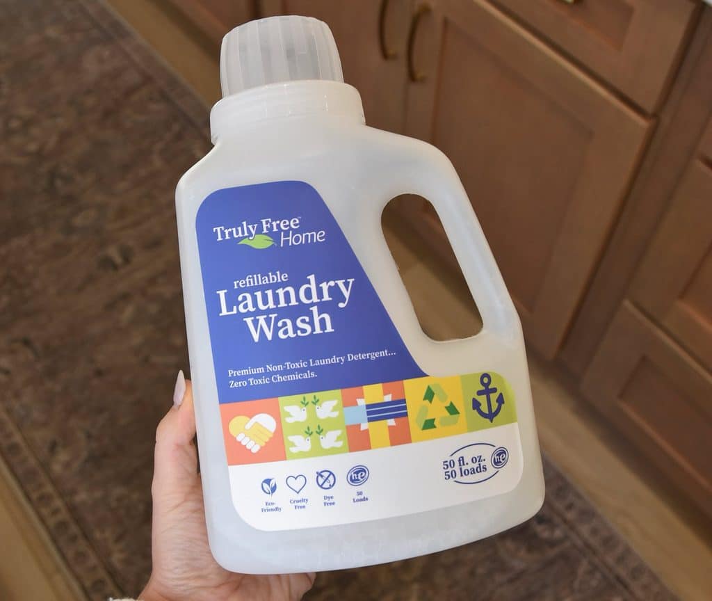 Holding the large jug of the Truly Free refillable laundry wash after it's been mixed up.