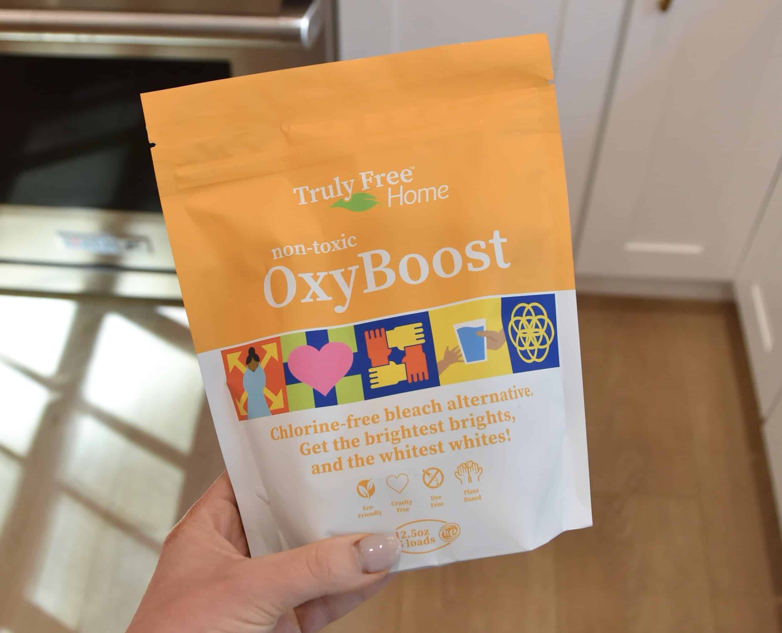 Holding a packet of the non-toxic OxyBoost from Truly Free to test and review.