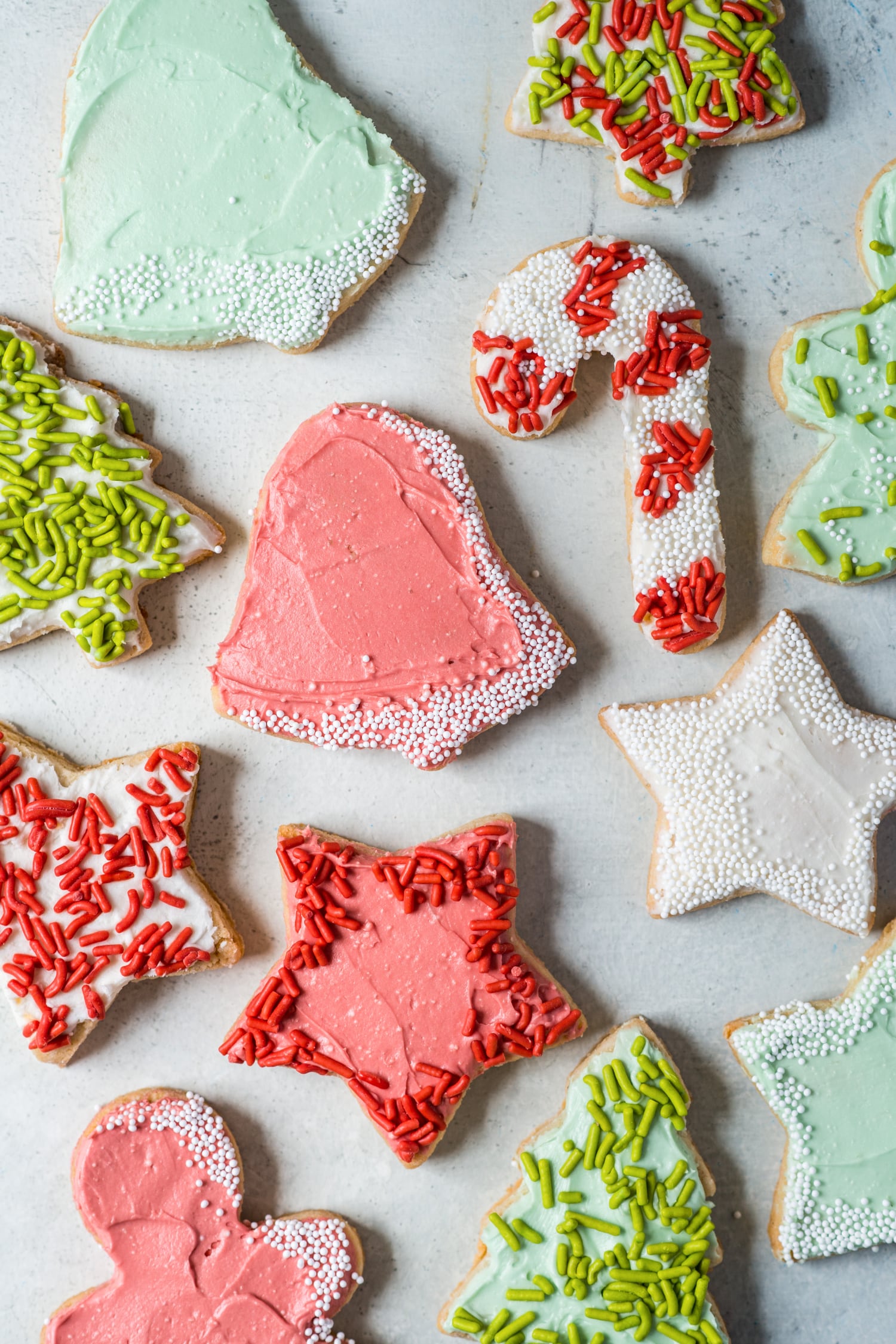 Almond flour sugar cookies cut into star, bell, and christmas tree shapes.