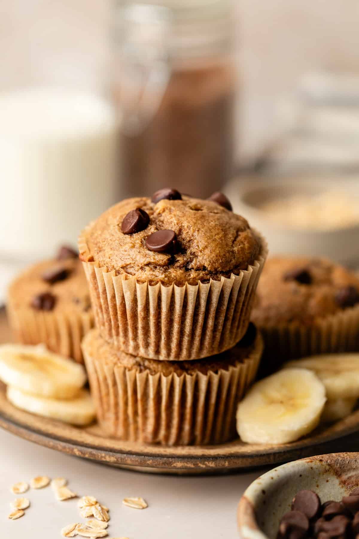 Two muffins stacked on top of each other on a plate.