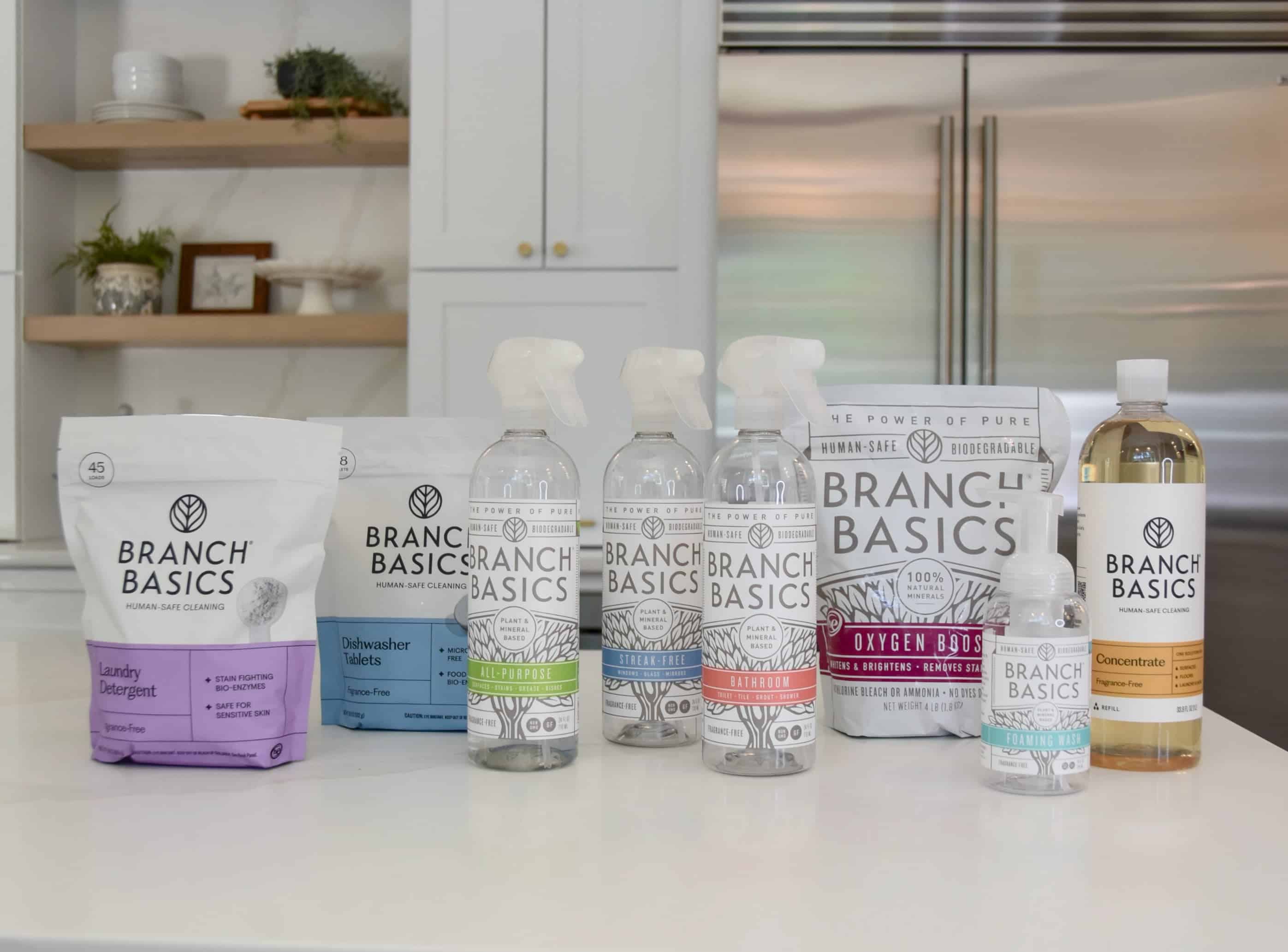 All of the branch basics products on the counter in the kitchen, including The Premium Kit, The Concentrate, and the laundry detergent and dishwasher tablets.