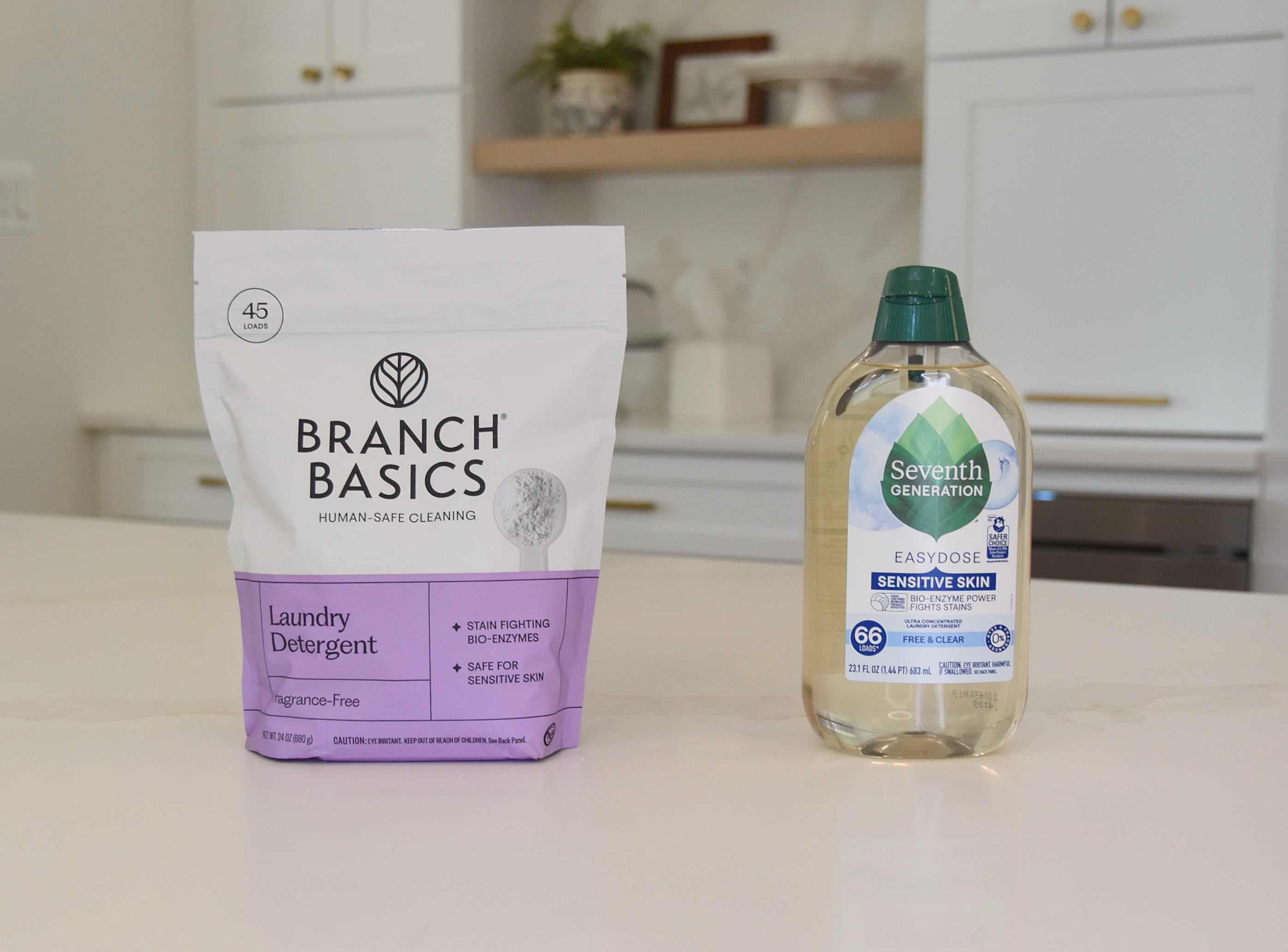 Showing the Branch Basics Laundry Detergent on the counter vs a bottle of the Seventh Generation liquid laundry detergent.