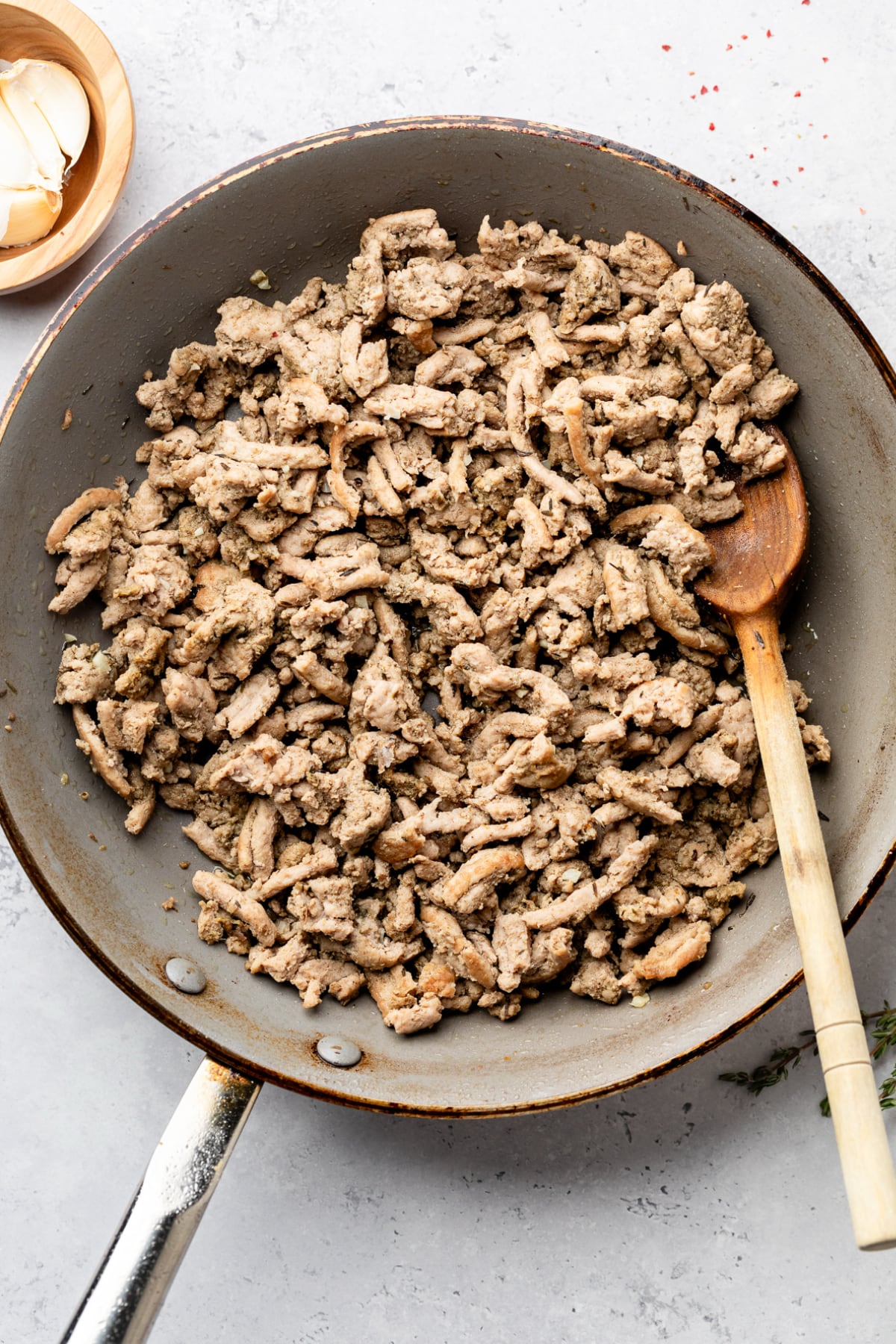 Browning ground turkey in the pan with maple syrup and spices.