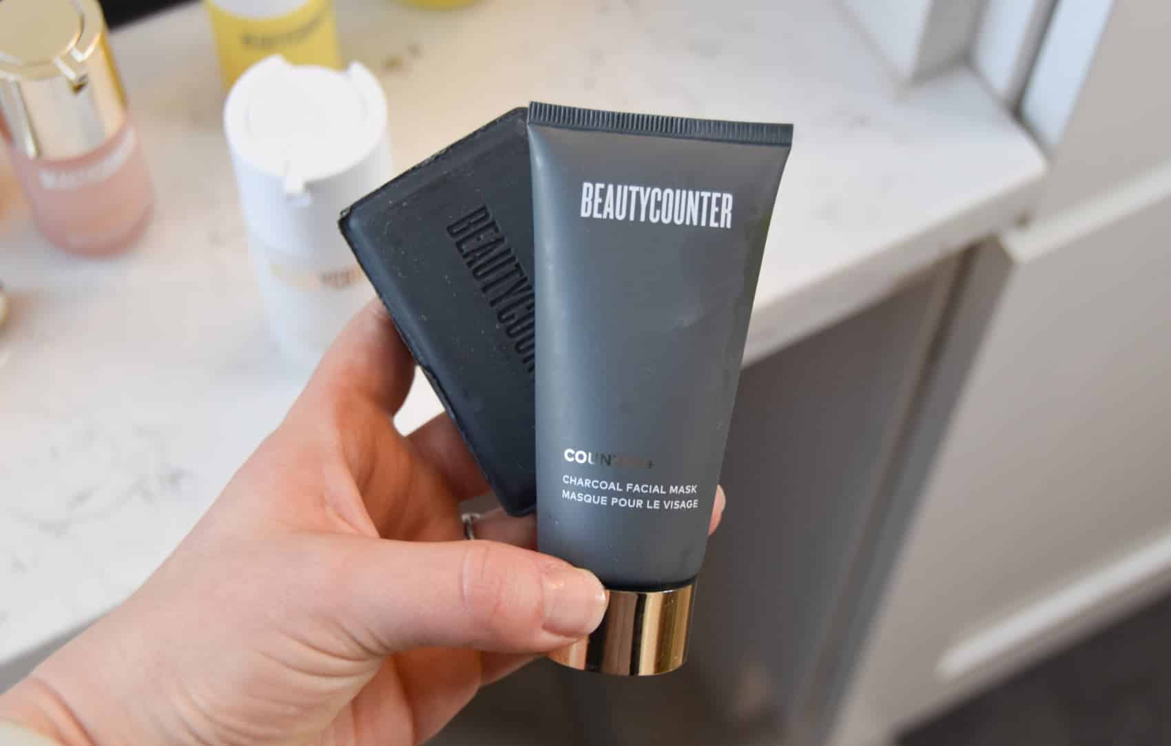 Holding onto the beautycounter charcoal mask and charcoal bar.