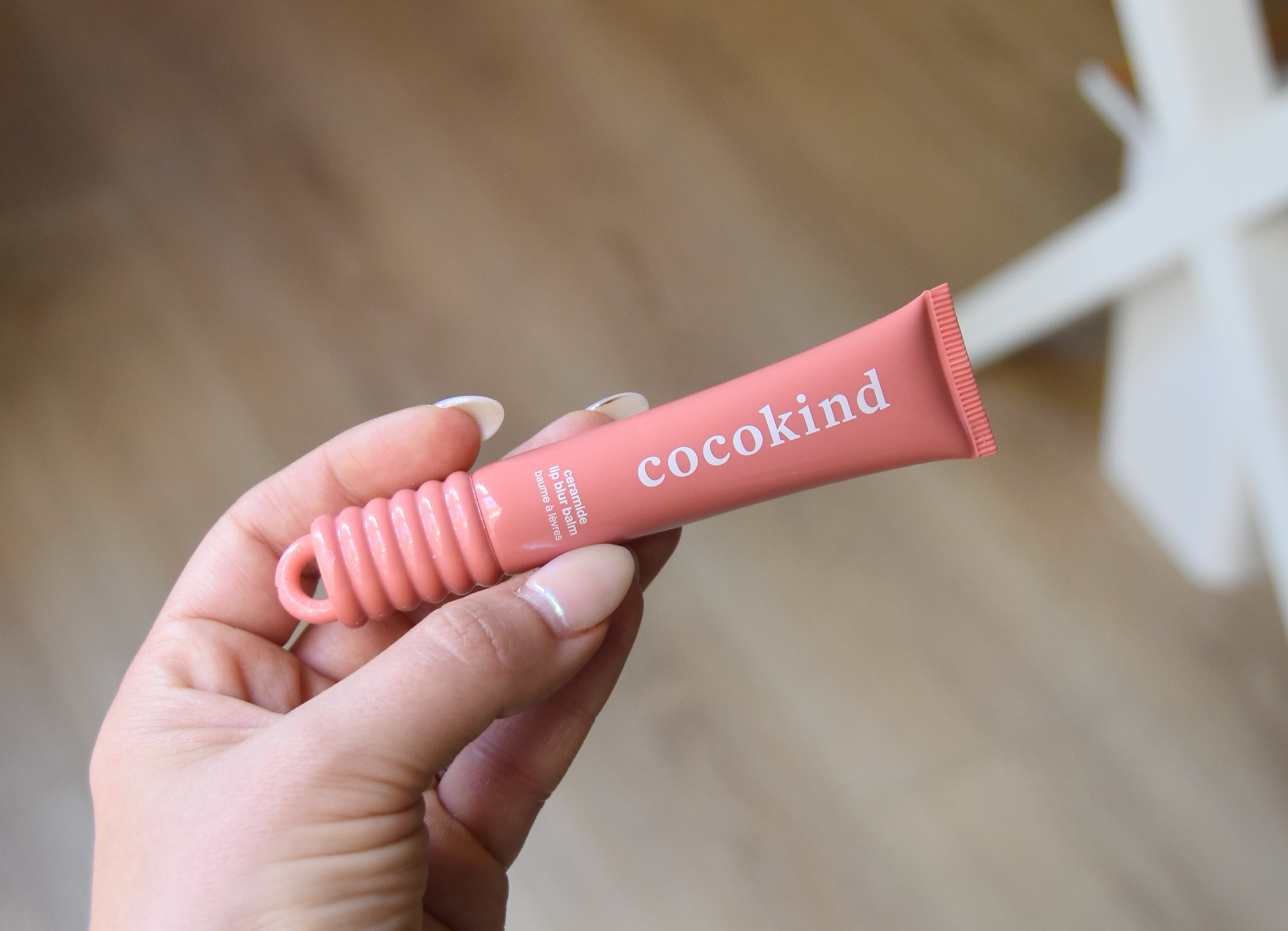Holding the cocokind ceramide lip blur balm.
