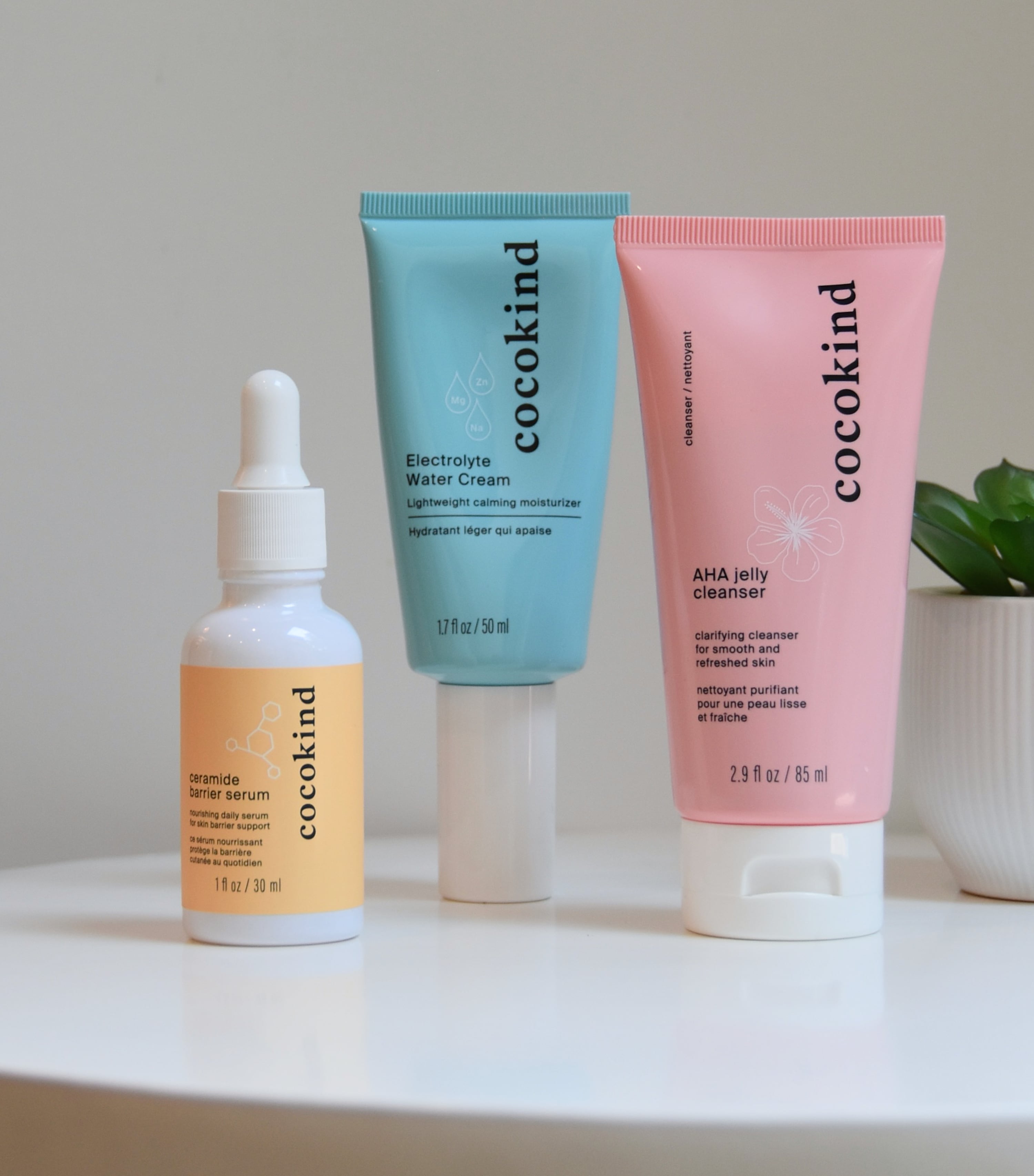 Three products, including the serum, electrolyte water cream, and AHA jelly cleanser on a table.