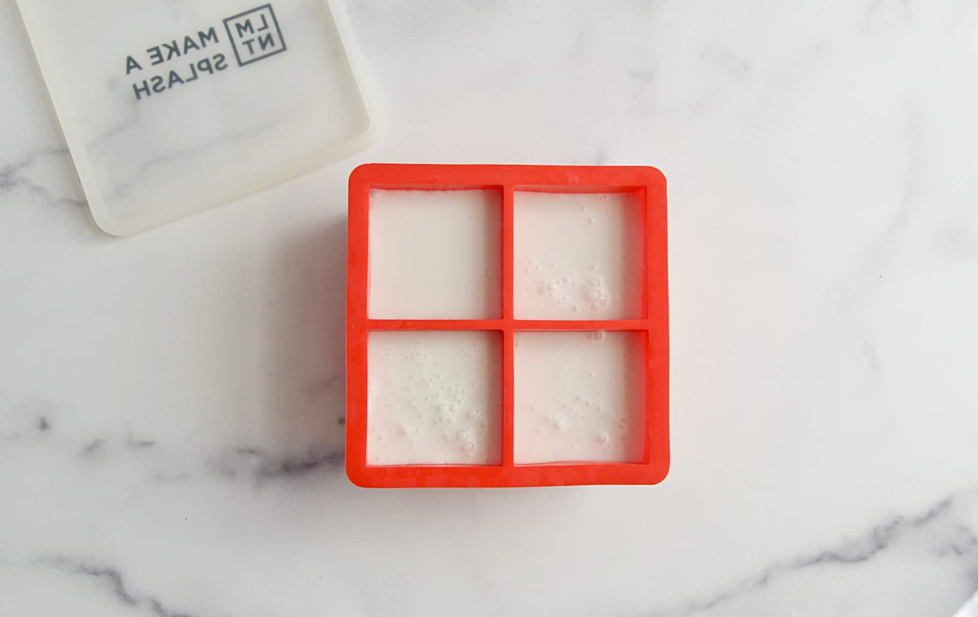 Coconut milk in an ice cube tray.
