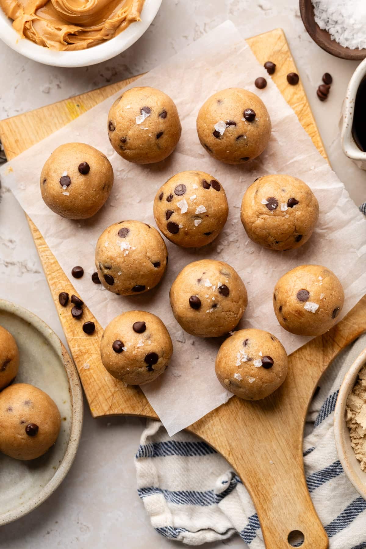 A serving platter with protein balls ready to eat for a snack with a little sea salt sprinkled on top.