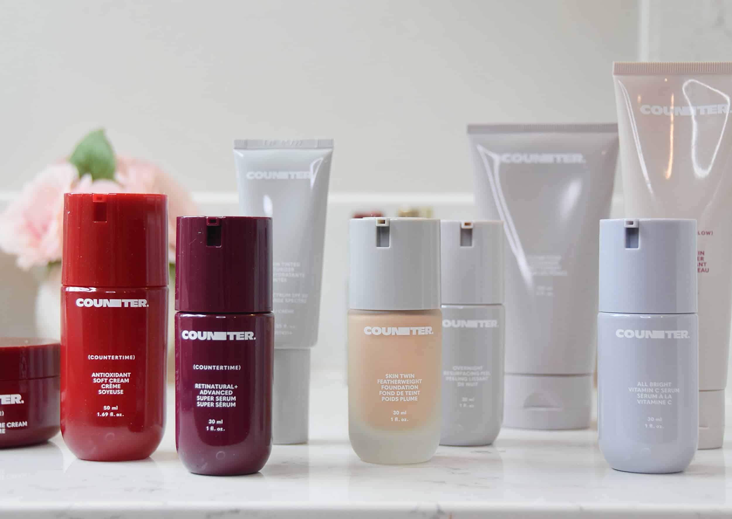 A group of Counter skin care and makeup products on the bathroom counter ready to be tested and reviewed.