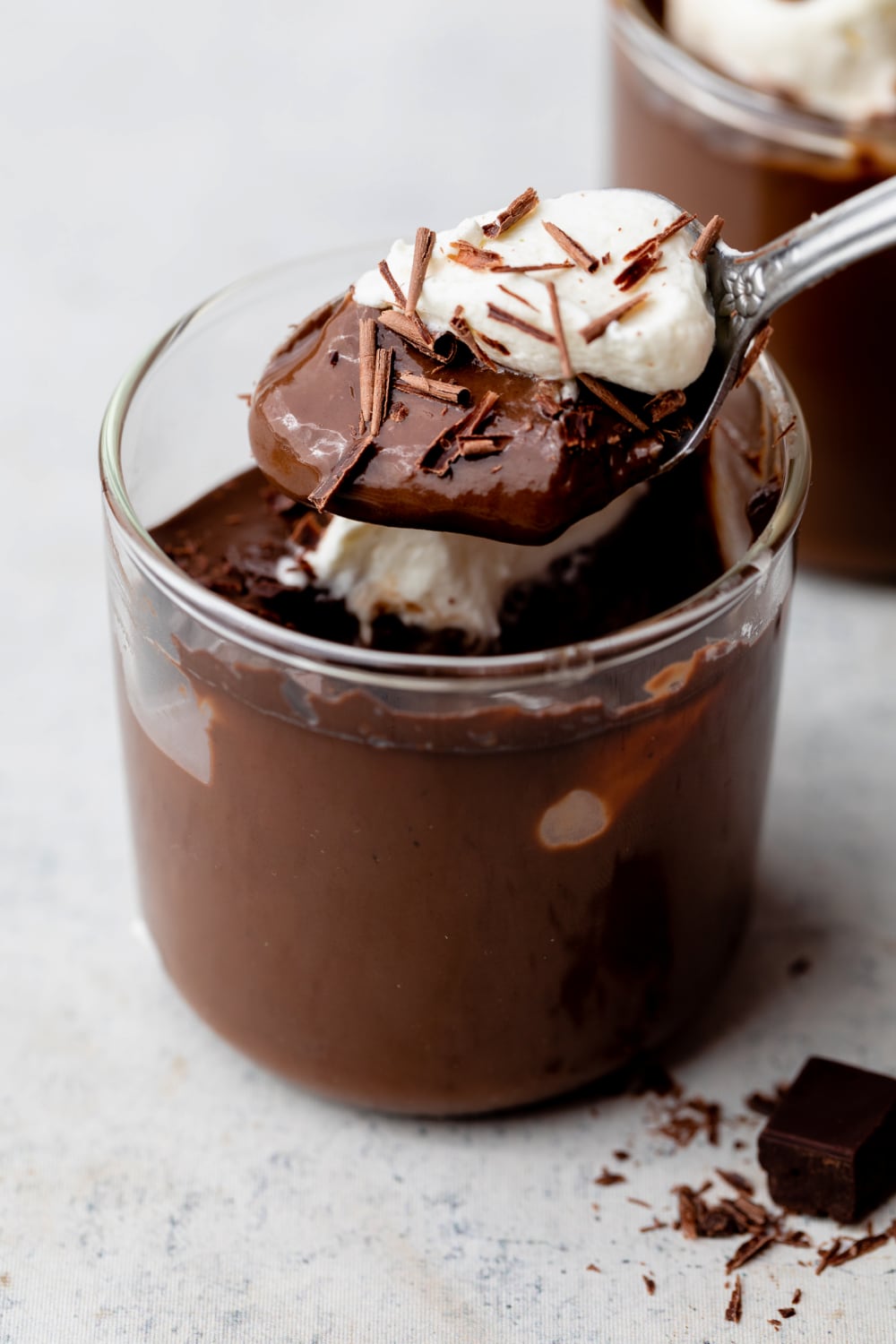 spoonful of dairy free chocolate pudding with vegan whipped cream.