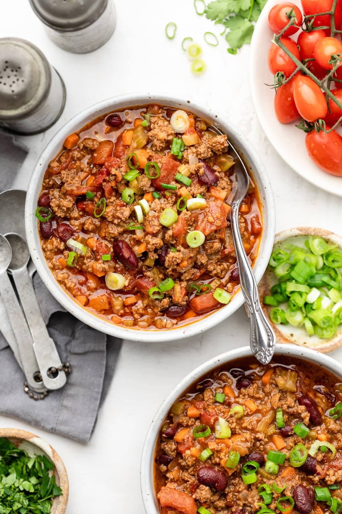 Bowl of easy chili recipe that can be made on the stovetop with a spoon in the chili.
