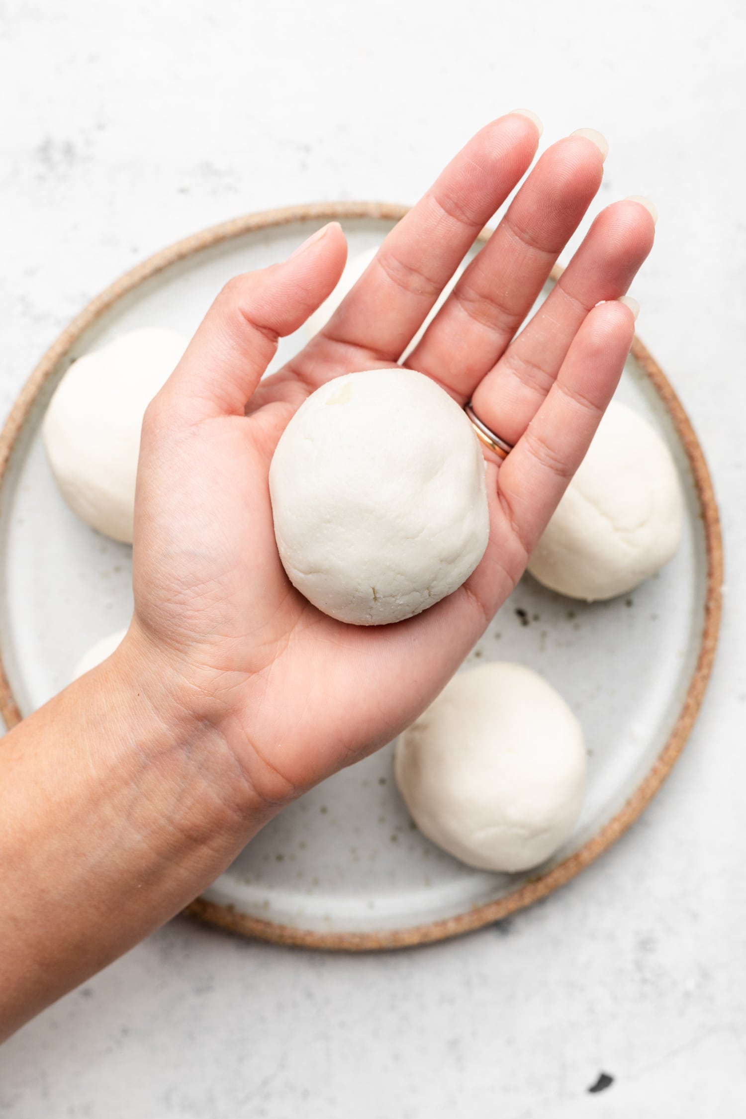 golf ball sized ball of naan dough in palm of hand
