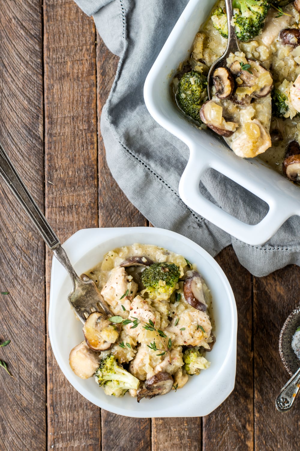 Small dish with paleo chicken broccoli casserole with a spoon. 