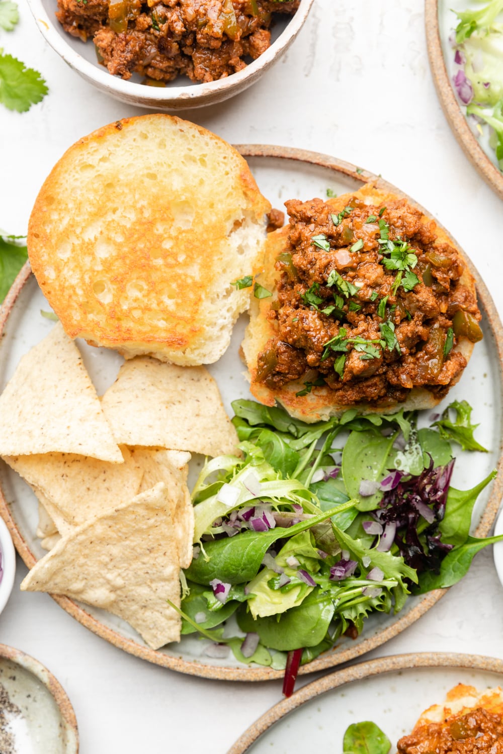 plated healthy sloppy joes with chips and a green salad
