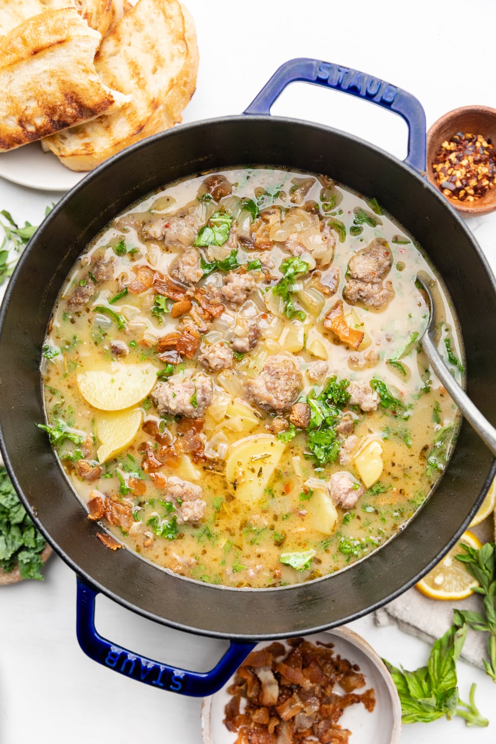 Large stockpot with healthy zuppa toscana soup and a spoon