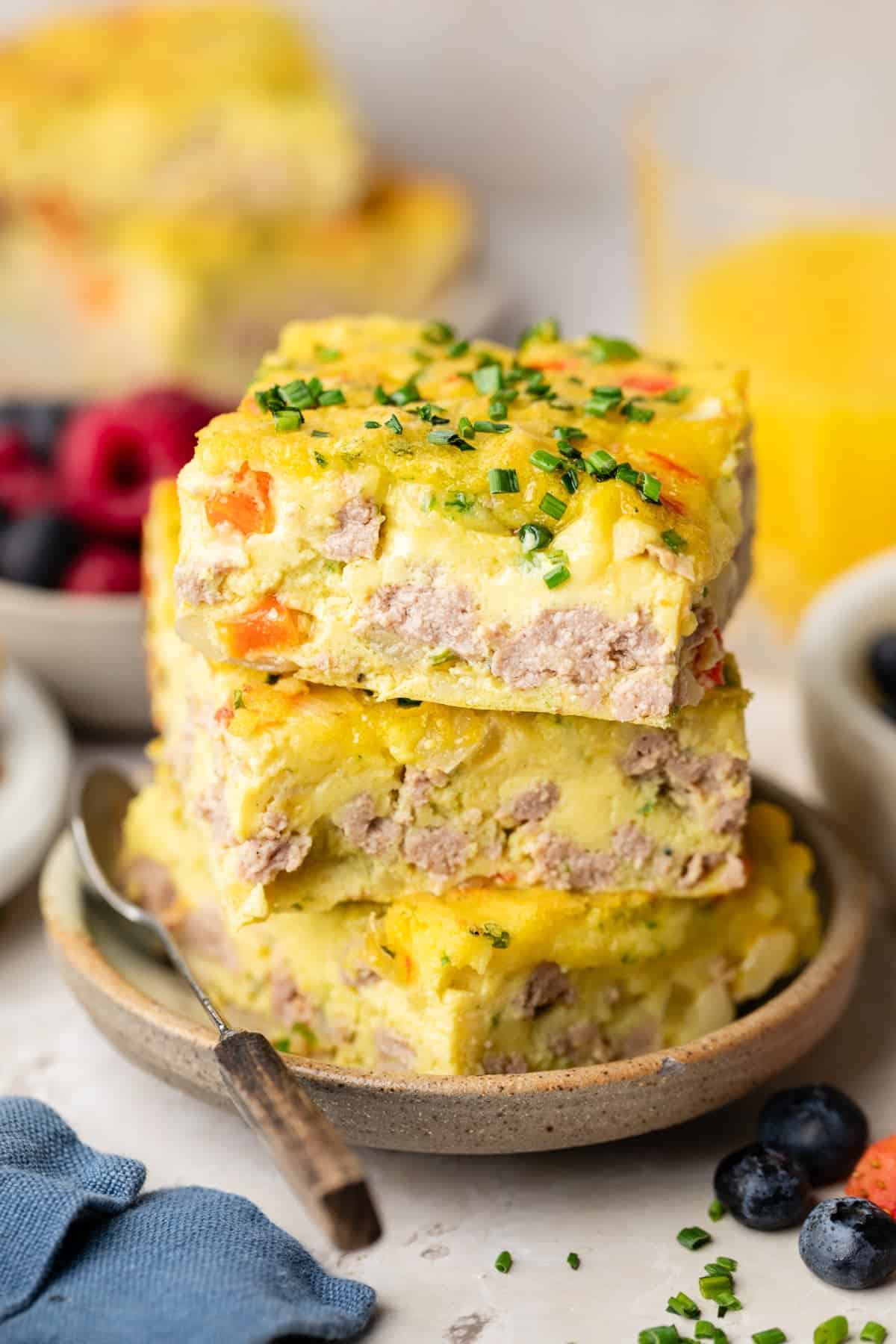 A stack of pieces of the high protein casserole, showing the inside with the bell peppers and turkey.