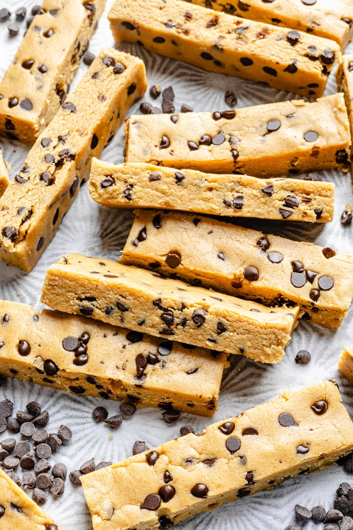 A variety of homemade protein bars cut up and laid out on a baking pan.