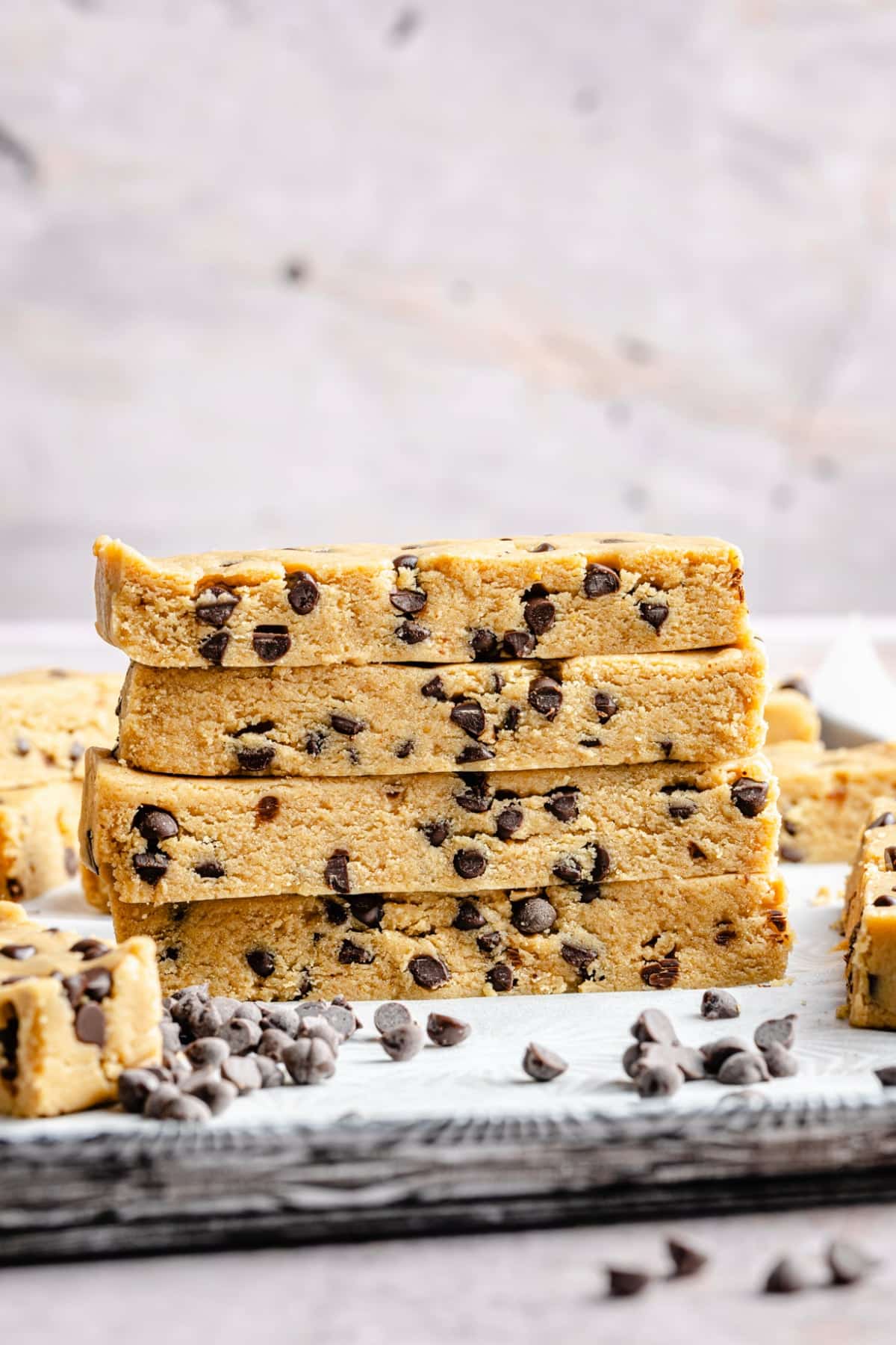 All of the homemade protein bars stacked on top of each other, showing the inside of the bar and what it looks like when cut up.