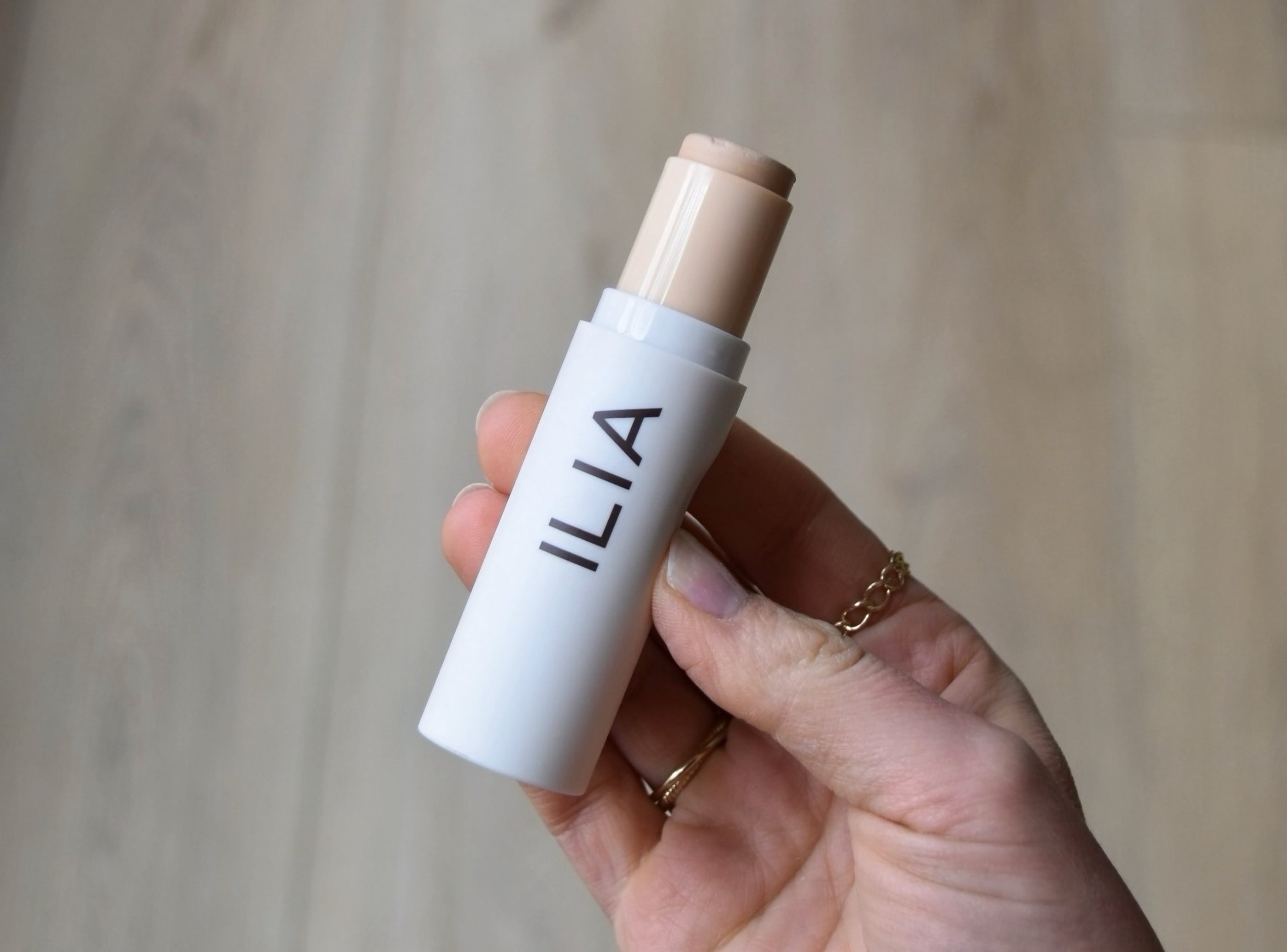 Holding the Complexion stick with the top off.