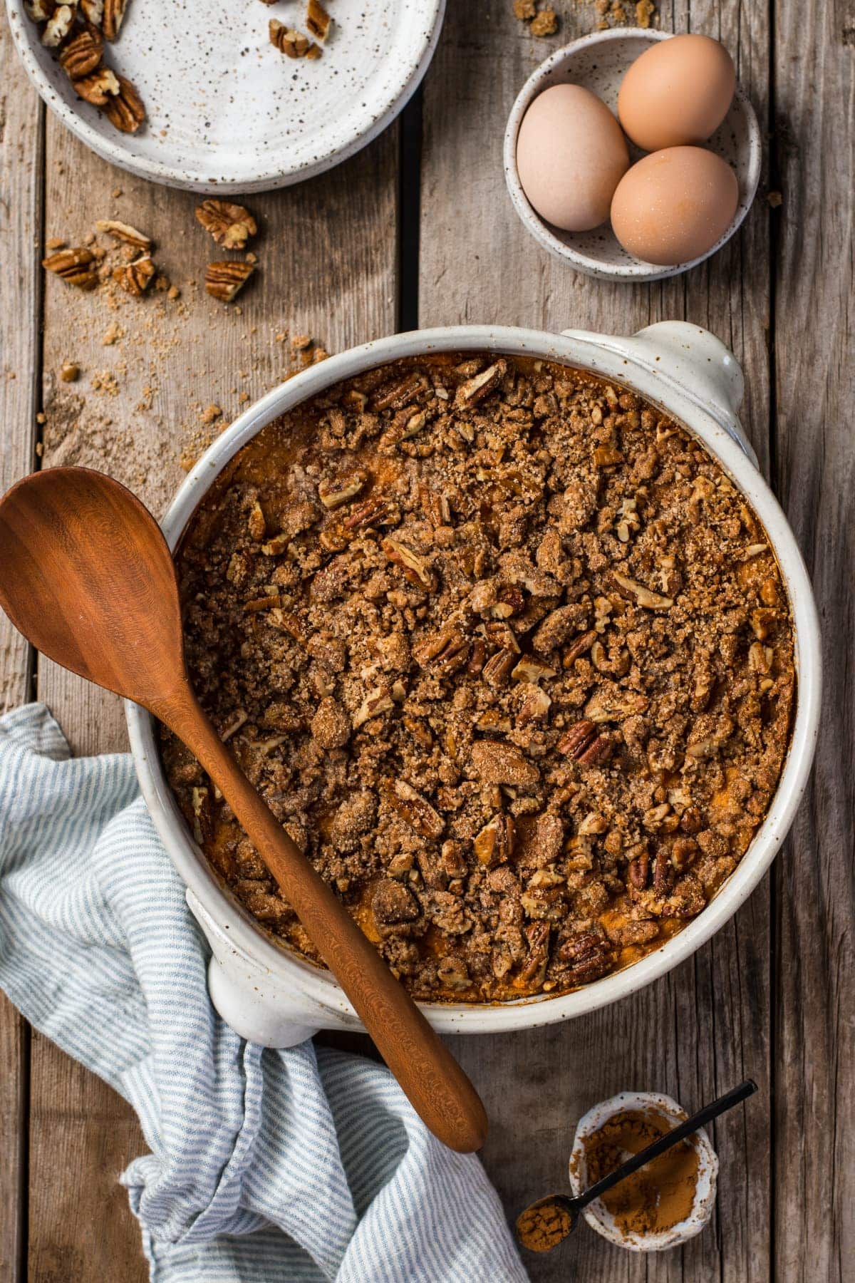 Some of the ingredients in the casserole on display, including sweet potatoes, eggs, warm spices, and pecans.