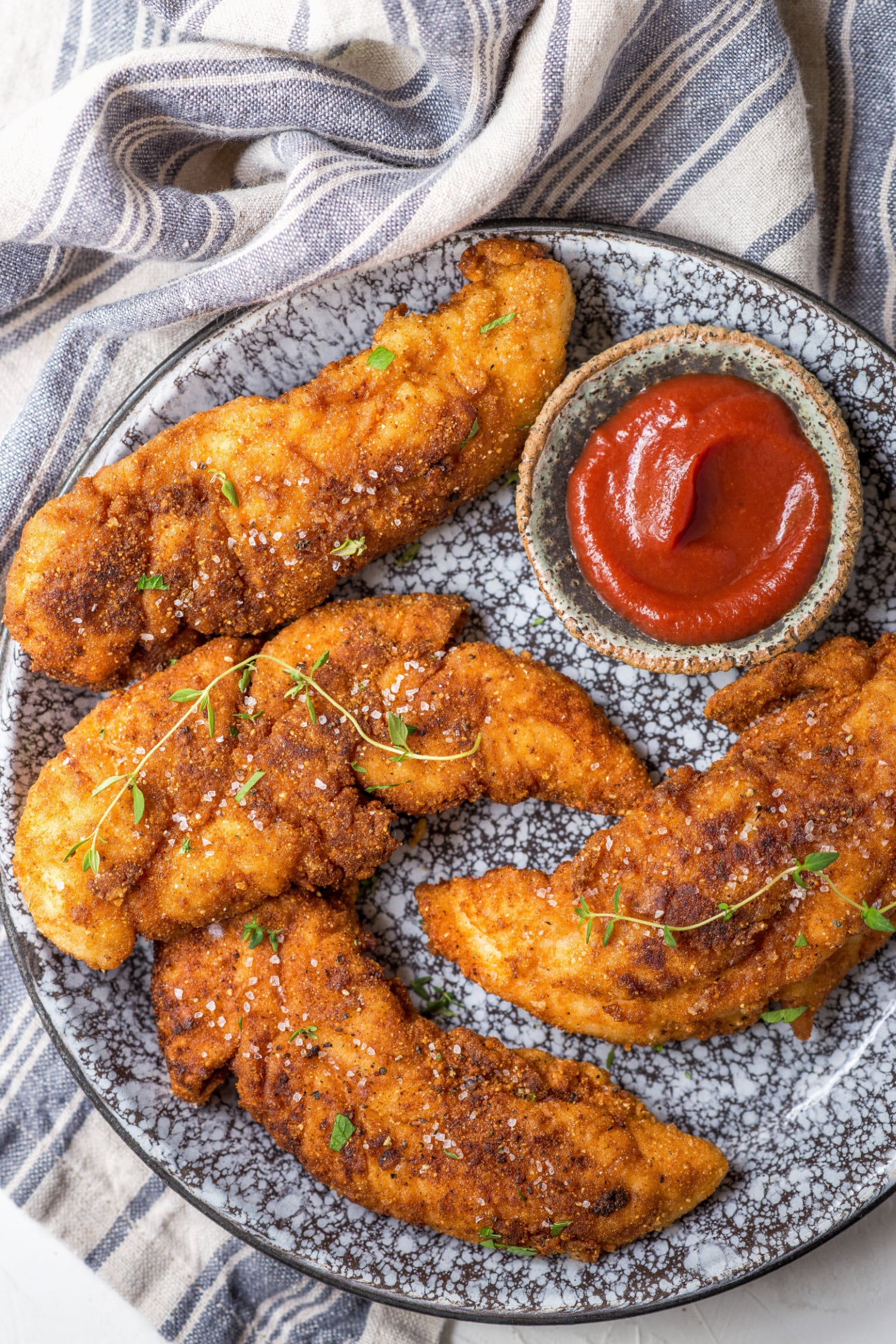 paleo chicken tenders on a plate with primal kitchen ketchup