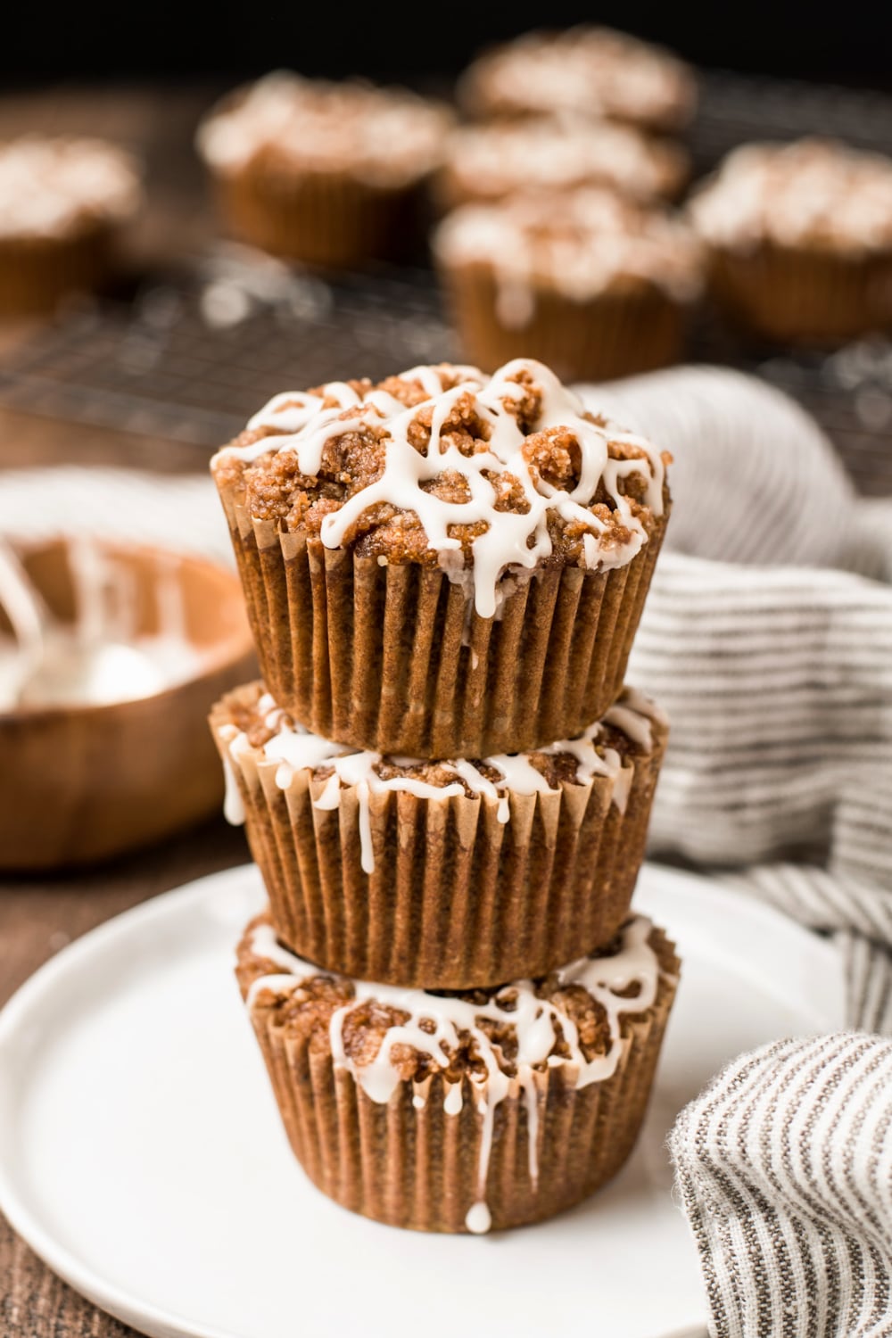 Three paleo pumpkin muffins stacked on top of each other. 