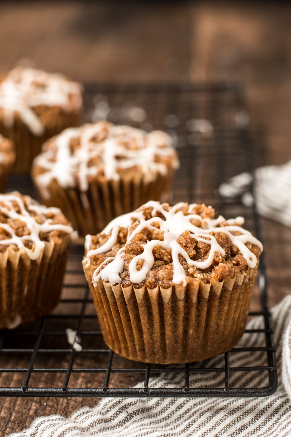 A pumpkin muffin cooling on a wire rack.