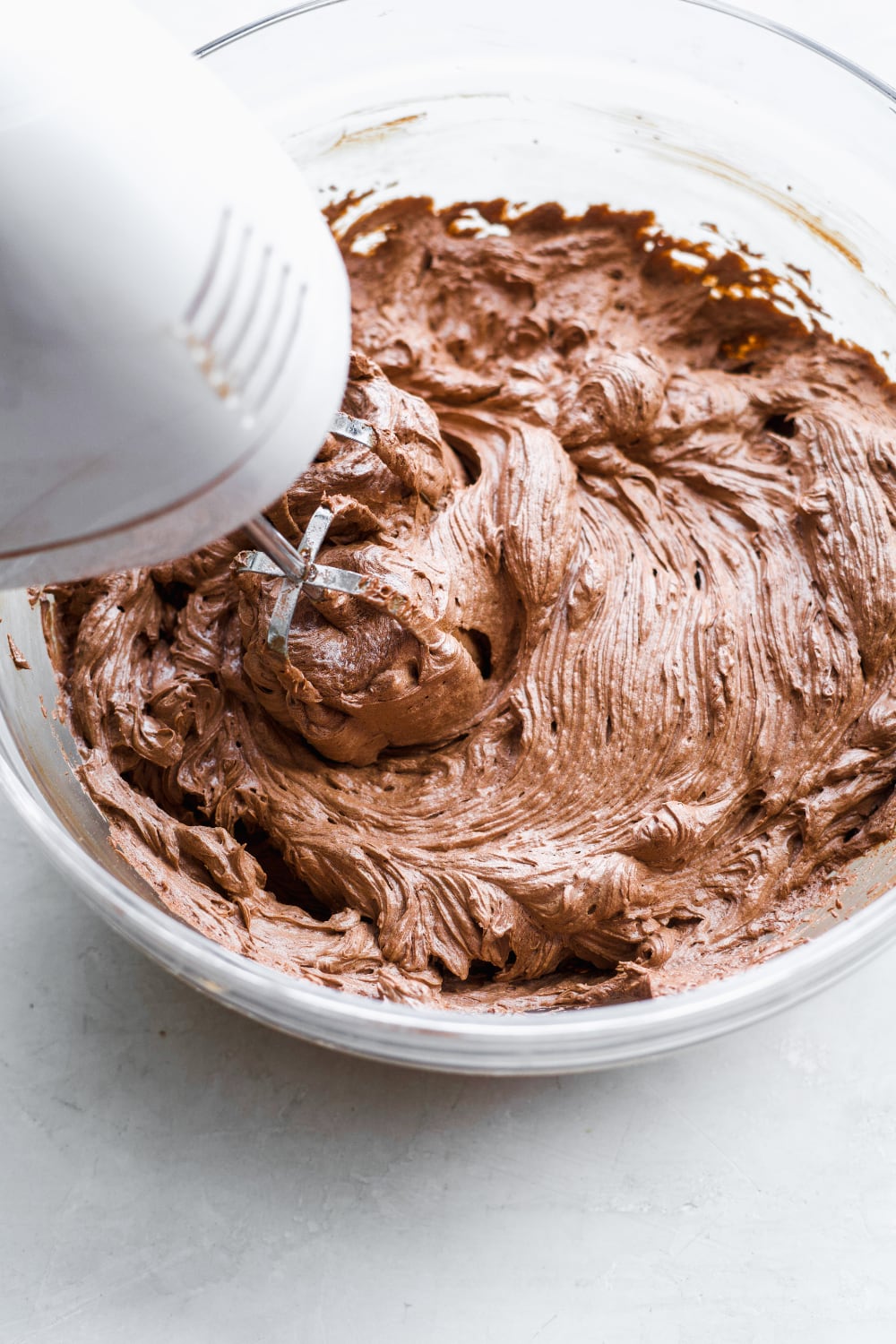 A big mixing bowl with dairy free chocolate frosting.