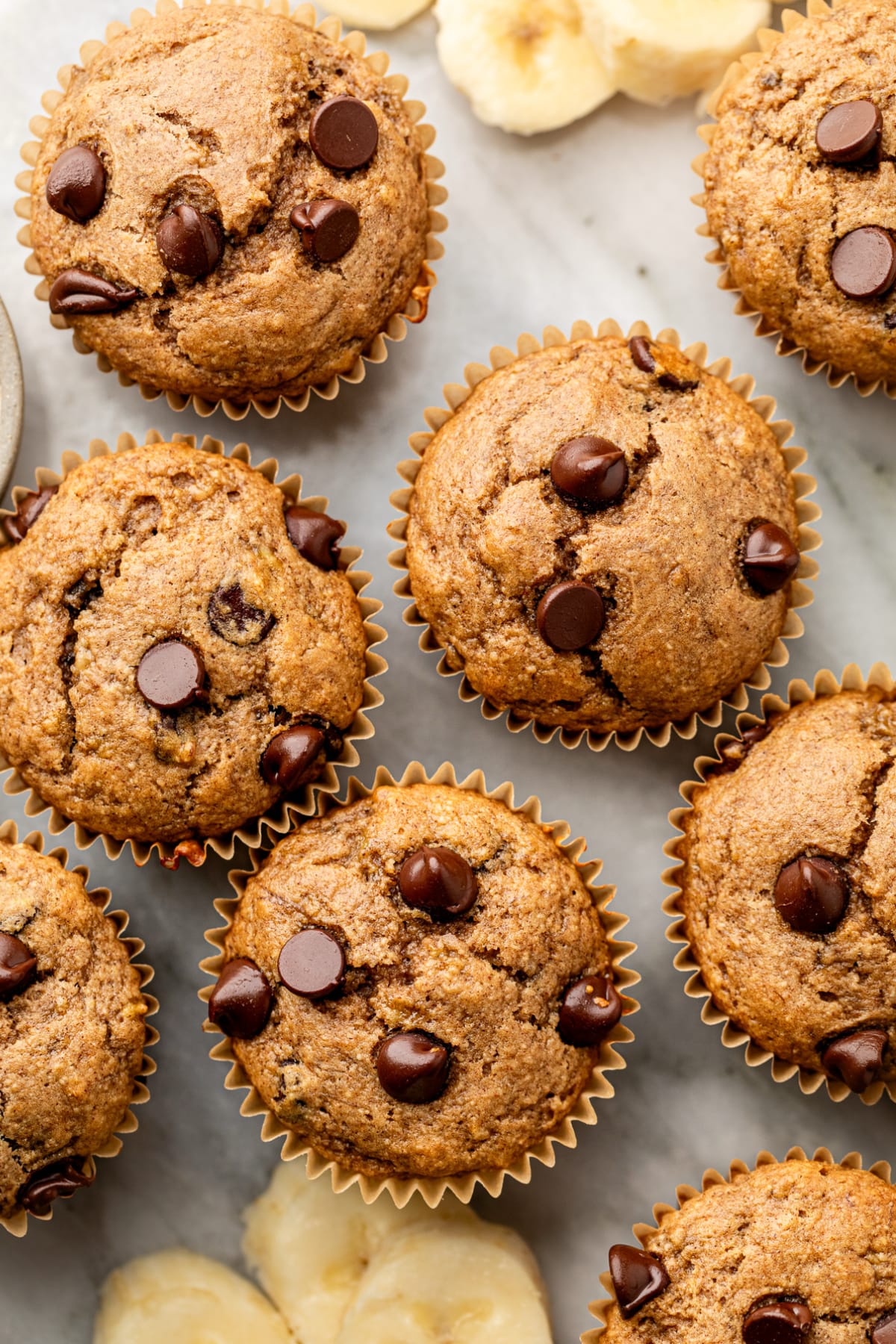 Looking overhead at a handful of muffins made with protein powder on the counter.