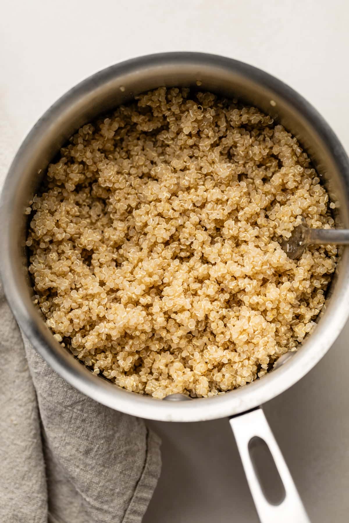 The quinoa cooked in the pan and ready to be assembled with the chicken in the bowl.