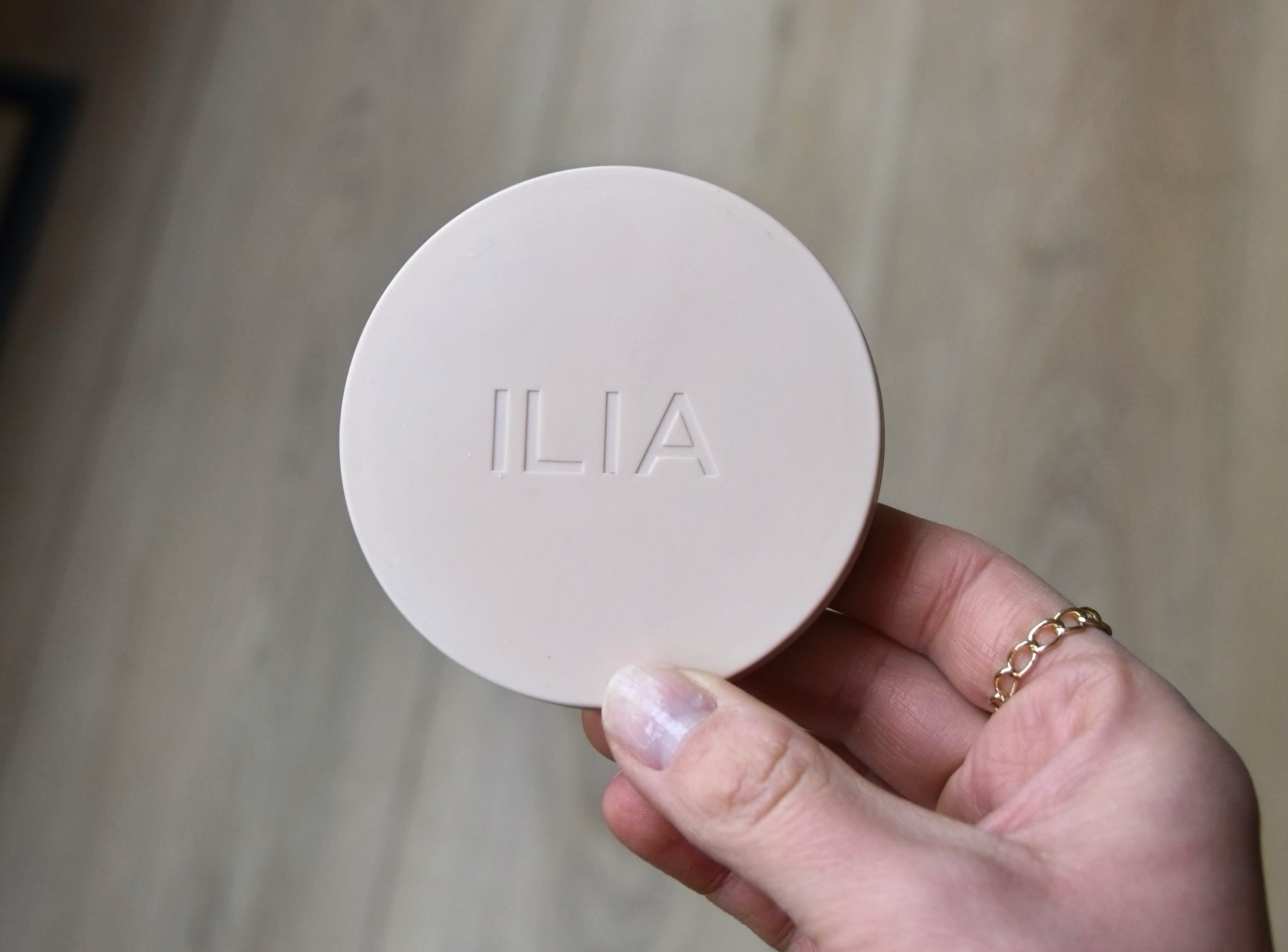 Holding the palette of the Lightshift Cream Highlighter.