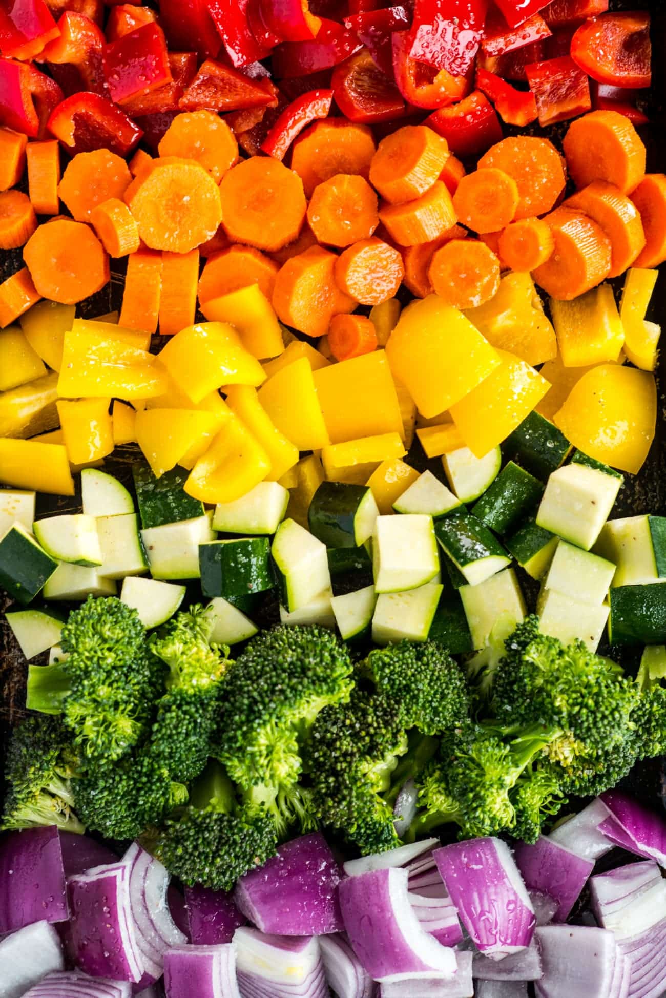 Chopped raw vegetables arranged on a platter ready to be cooked.