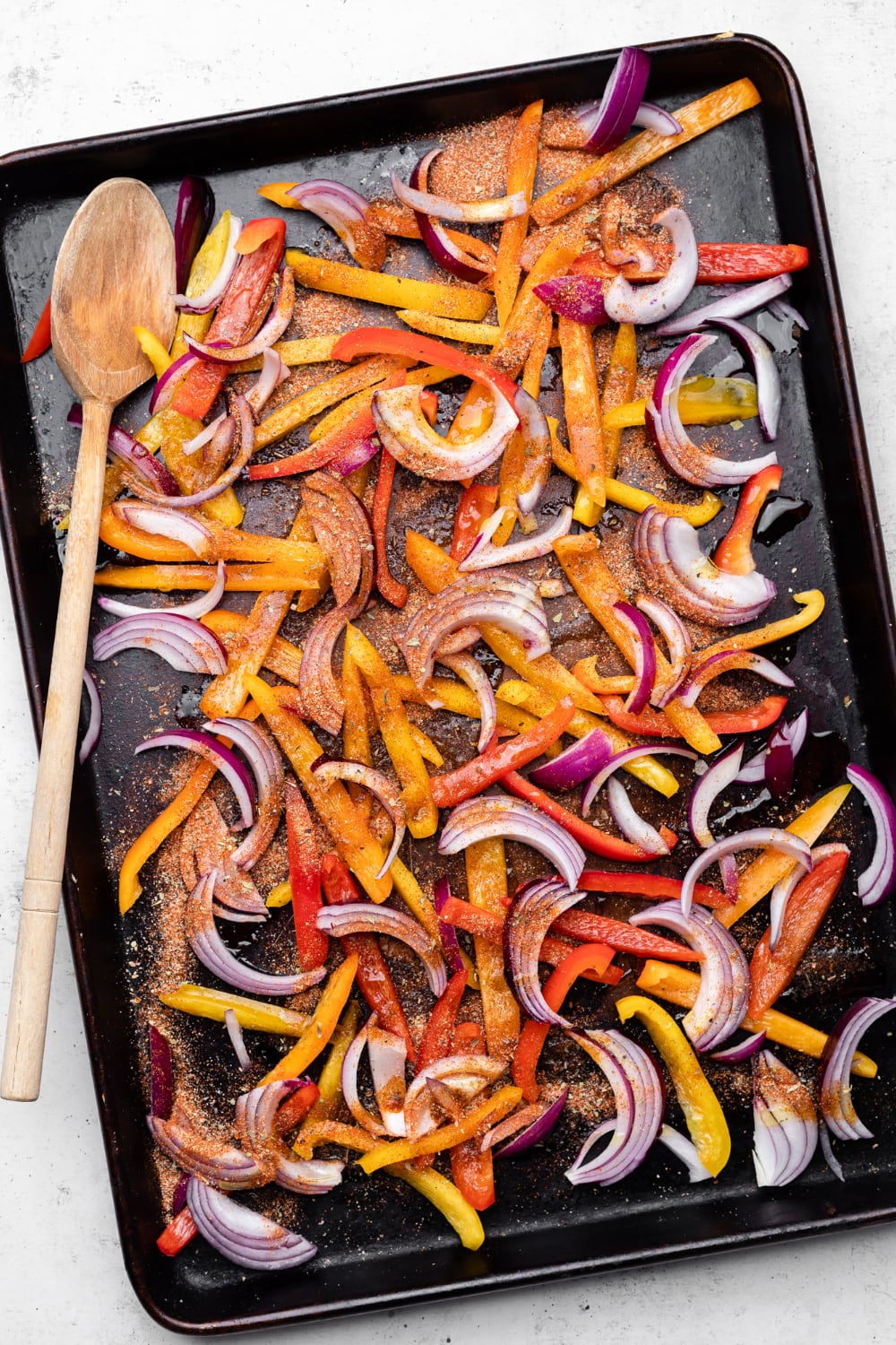 veggies and peppers on a pan with seasoning