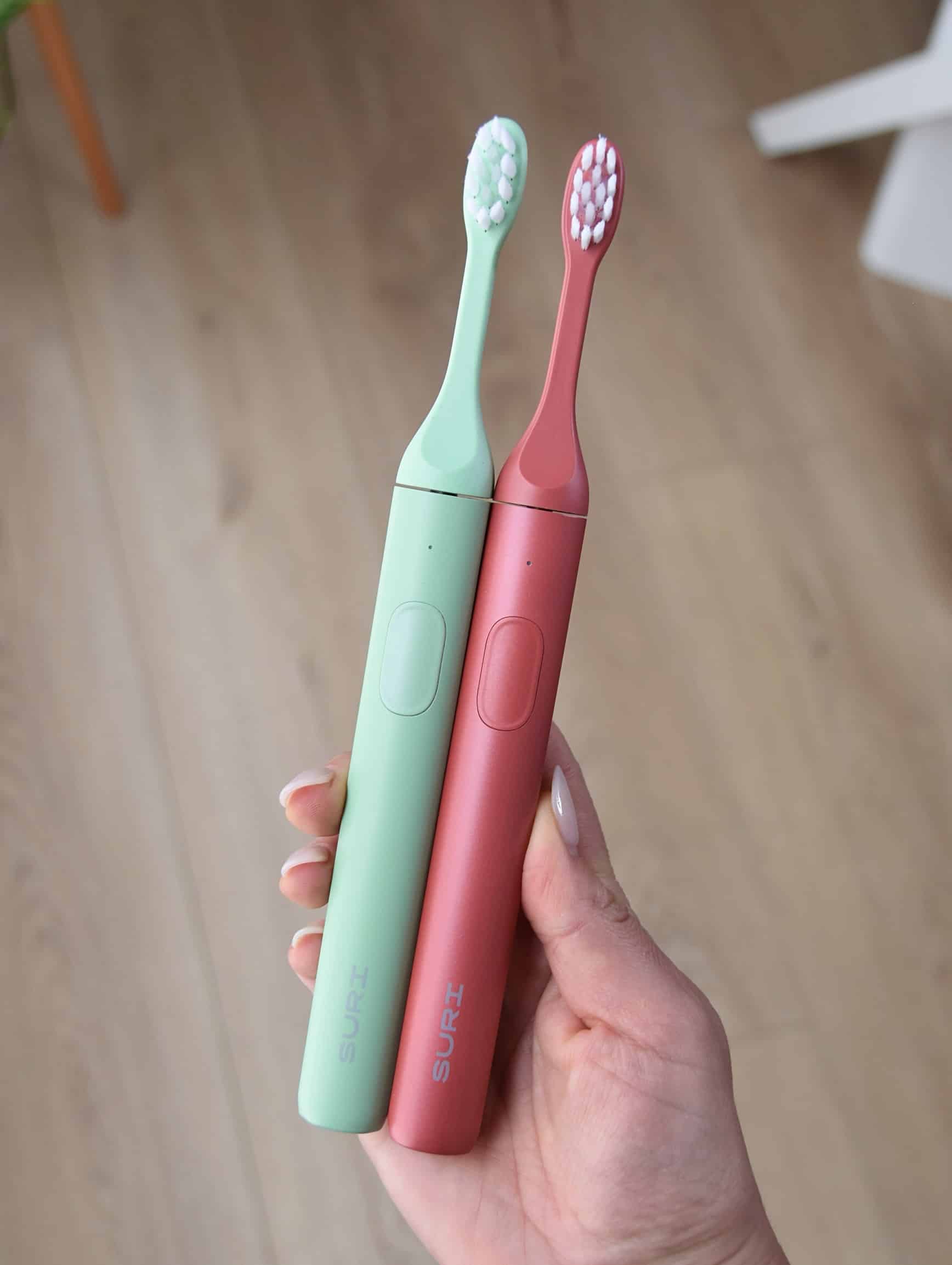 Comparing the SURI 1.0 vs 2.0 toothbrush side by side.