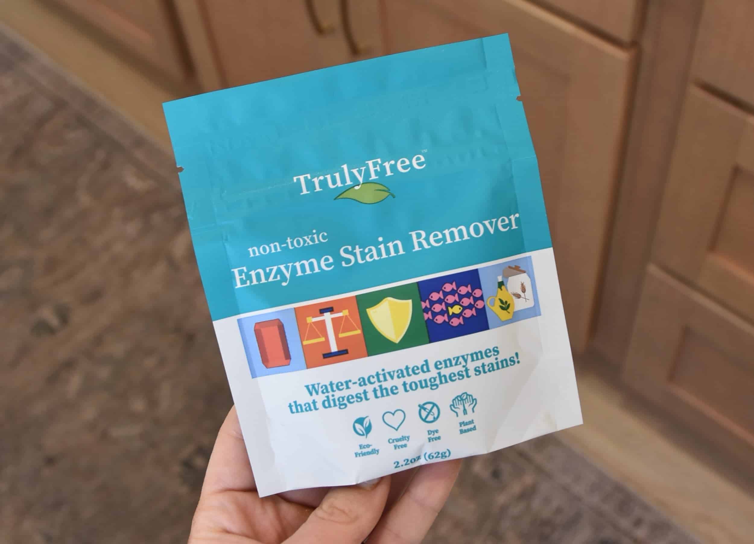 Holding a packet of the Truly Free Enzyme Stain Remover.