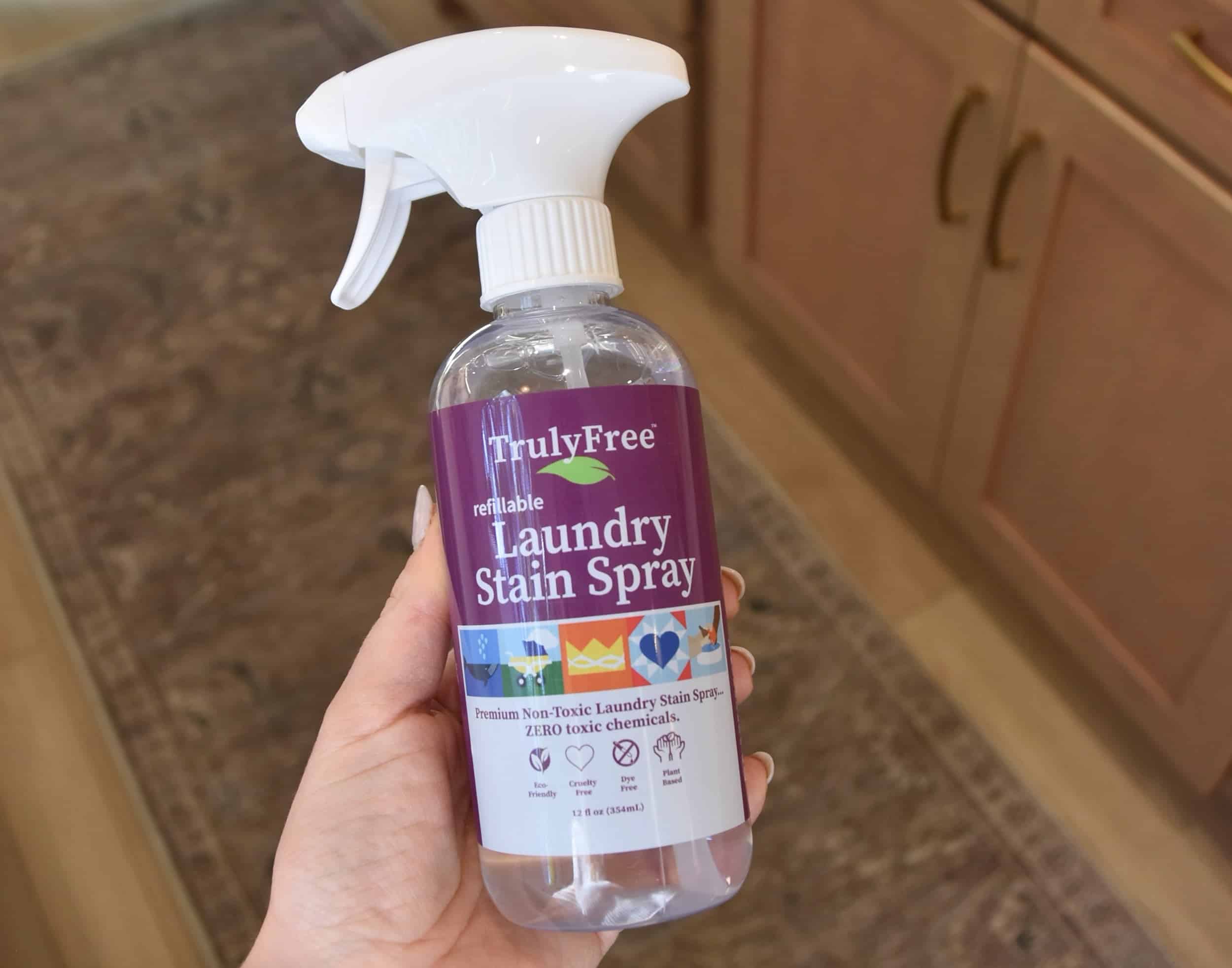 Holding the Laundry Stain Spray with the concentrate added and the water added to make a full spray bottle.